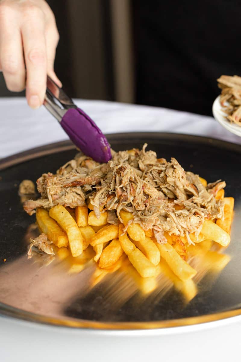 Spread the Warm Smoked Pulled Pork over top the Fries