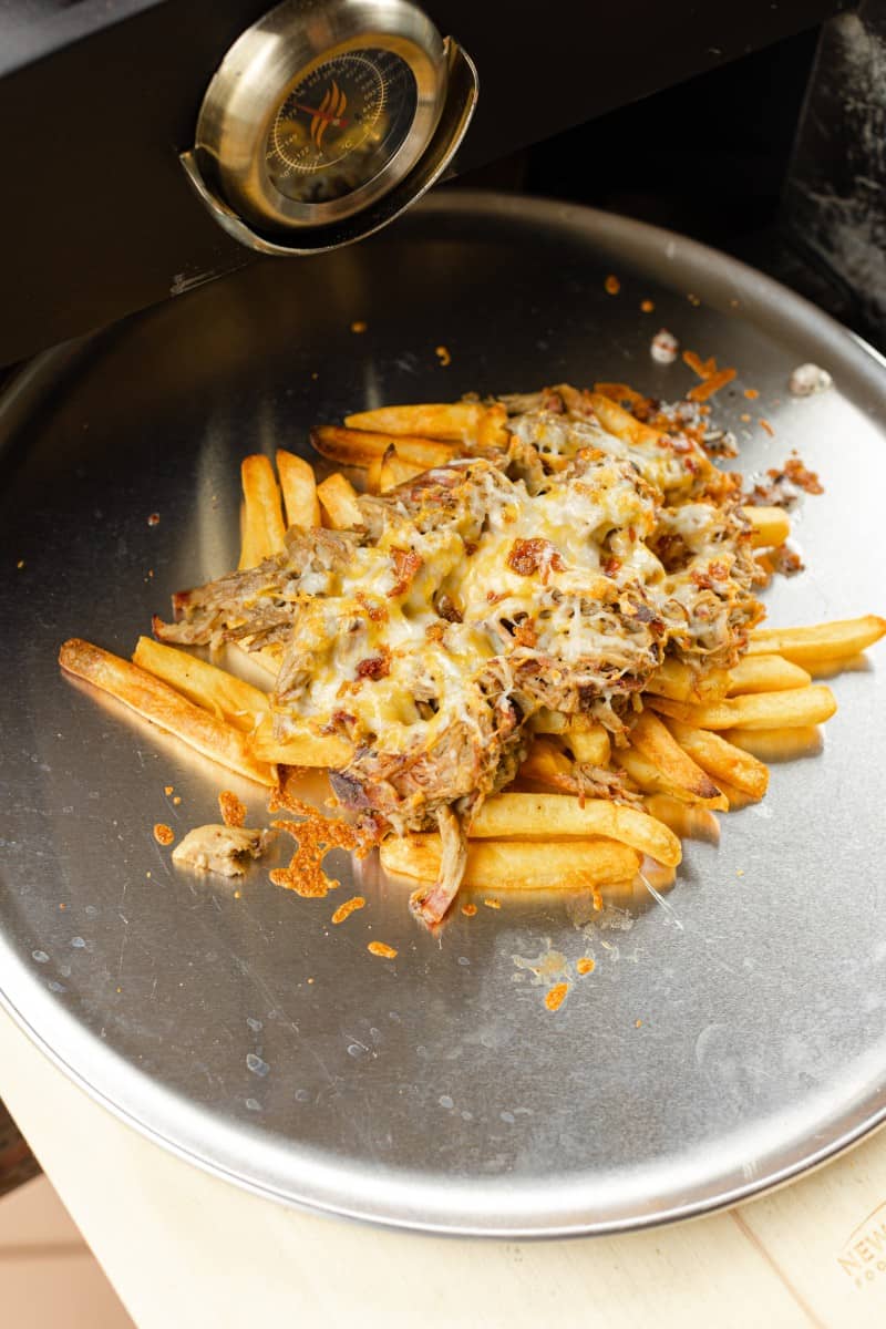 Place the Prepared Pan of French Fries with Pulled Pork into the Blackstone Pizza Oven