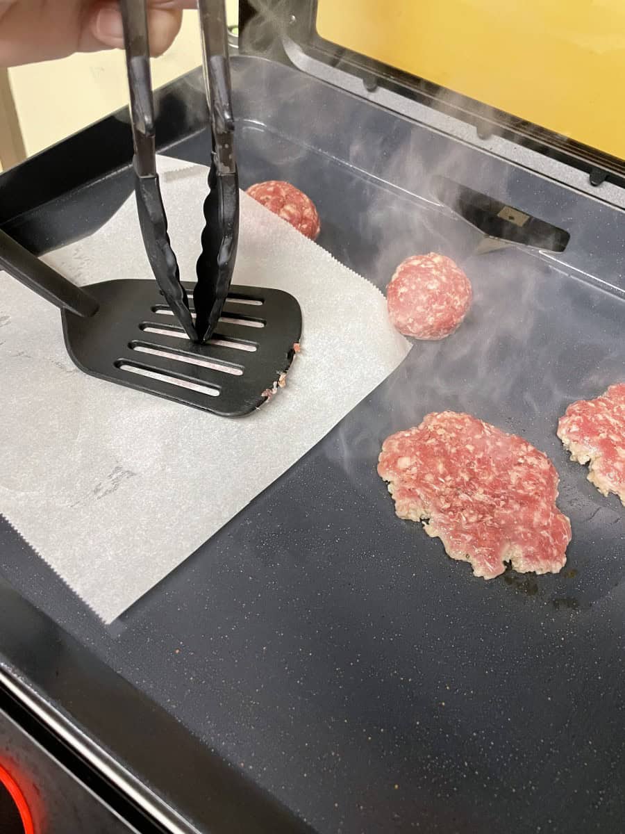 Using a Plastic Spatula to Smash a Burger on an Electric Griddle.
