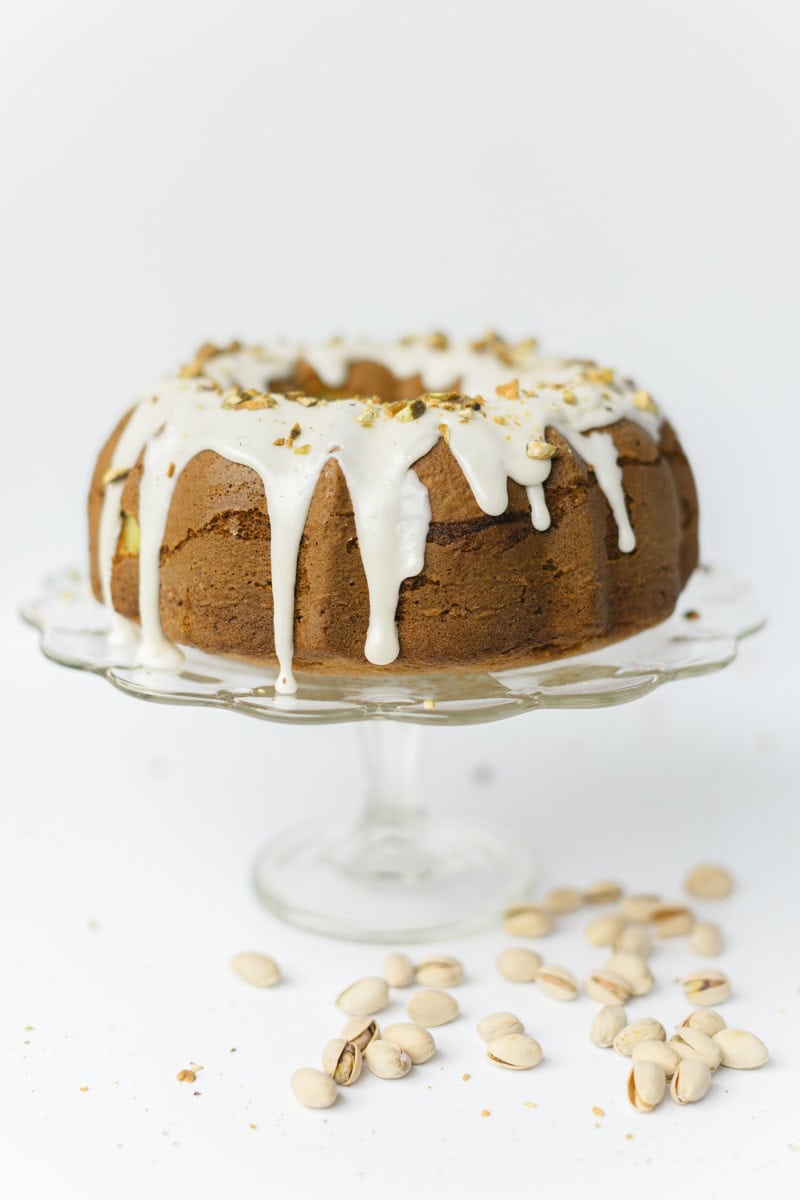 Pistachio Pudding Cake Drizzled with White Icing and Crushed Pistachio Nuts