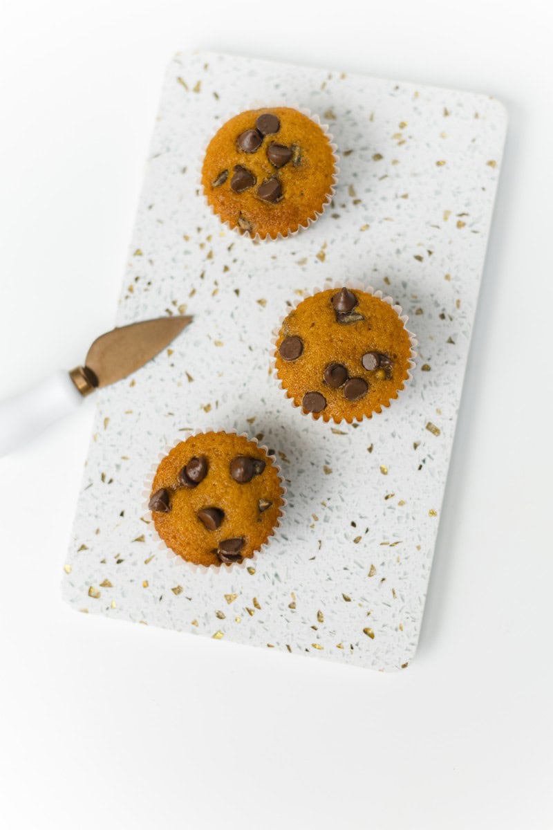 Pumpkin Chocolate Chip Cupcakes on a Board with a cutting knife