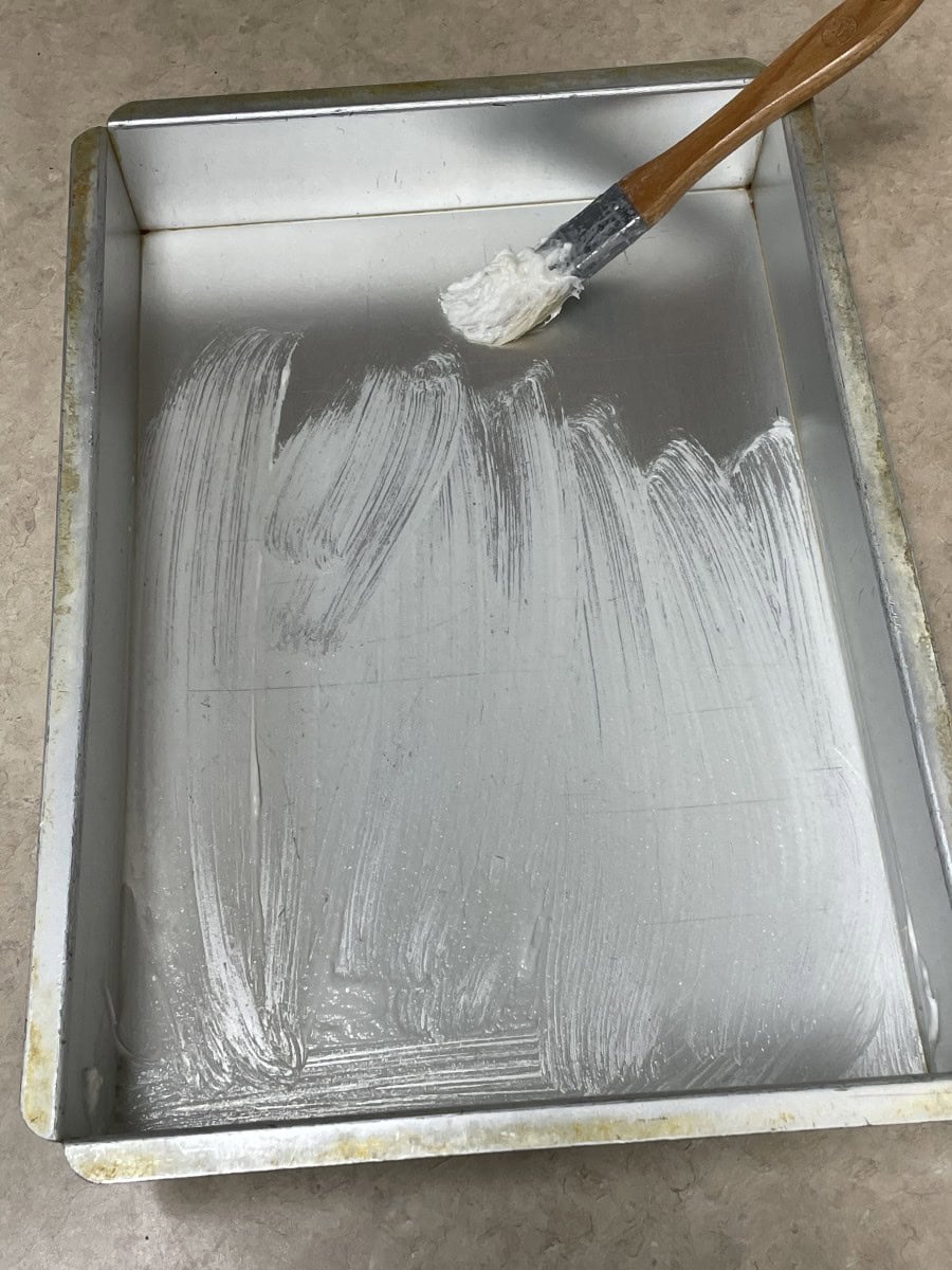 Coat the Inside of the Cake Pan with Pan Grease using a pastry brush