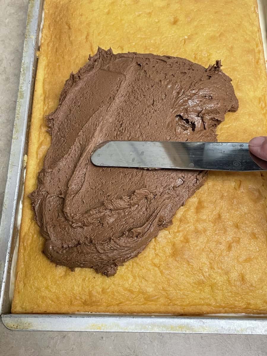 Spread a thin, even layer of the Chocolate Frosting onto the Top Layer of Cake