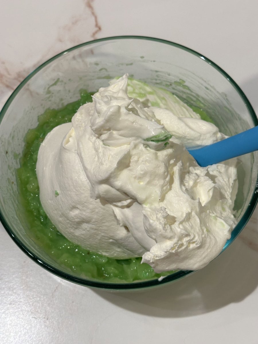 Fold the Cool Whip into the Jello/Pineapple Mixture