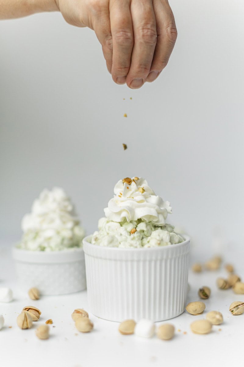 Serve the Watergate Salad Recipe in Small Dishes.  Top with Whipped Cream and Crushed Nuts.
