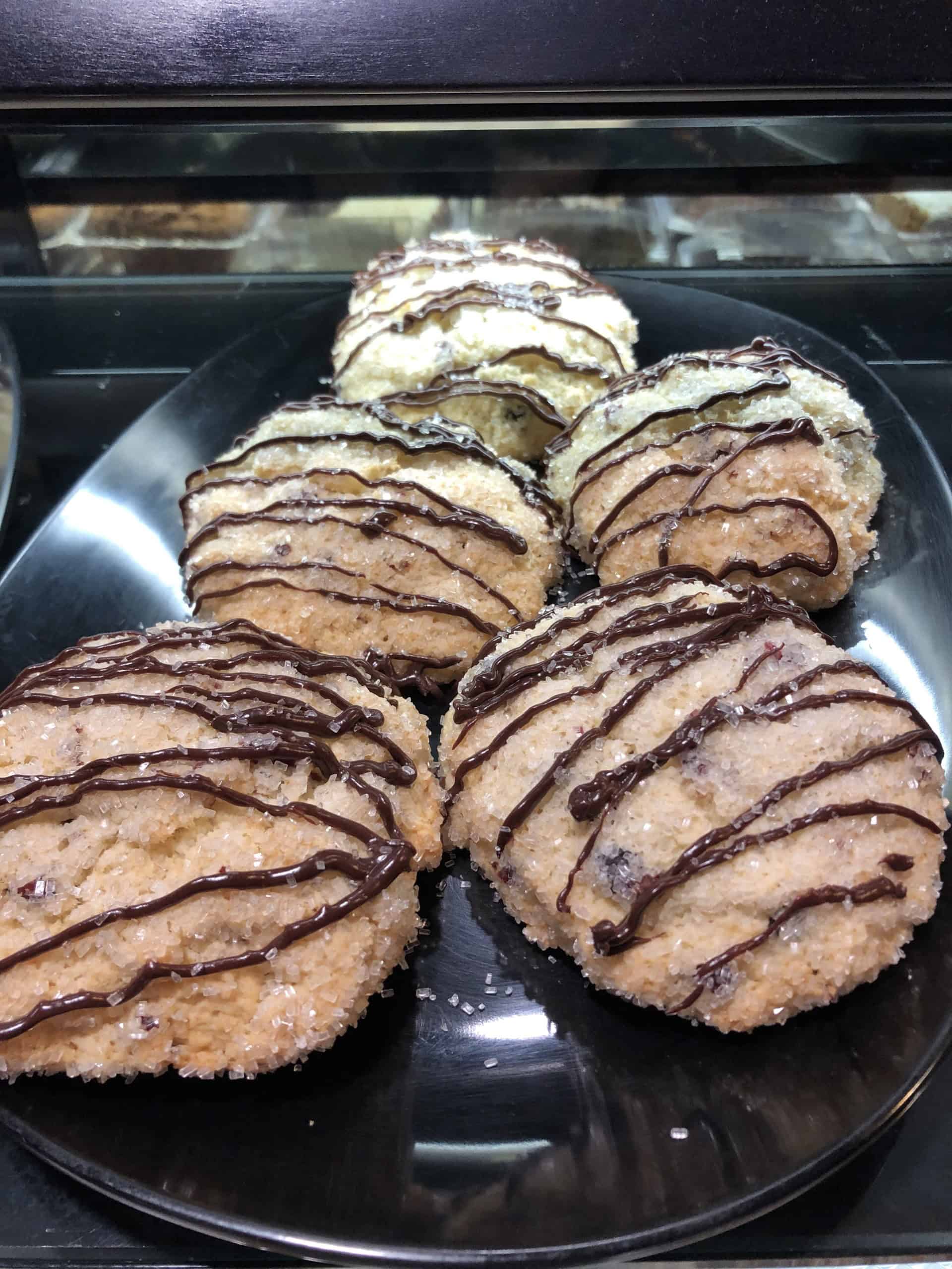 Garnished Chocolate Covered Berry Scomuffies in a Pastry Showcase