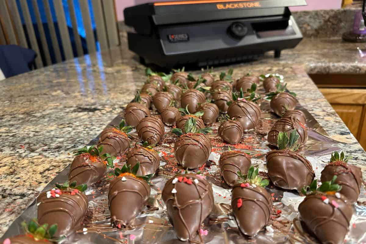 Blackstone Griddle Chocolate Dipped  Strawberries on a sheet of foil