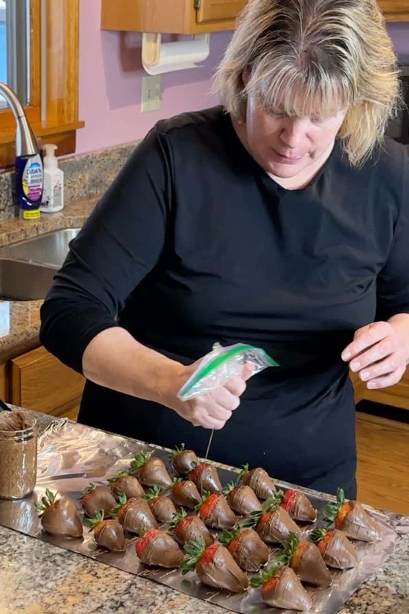 Learn How Chef Sherry Ronning Drizzles Melted Chocolate overtop of Chocolate Strawberries.