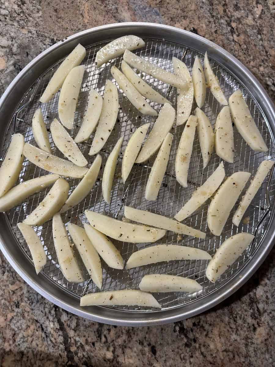 Raw Potatoes Fries on a Wire Rack