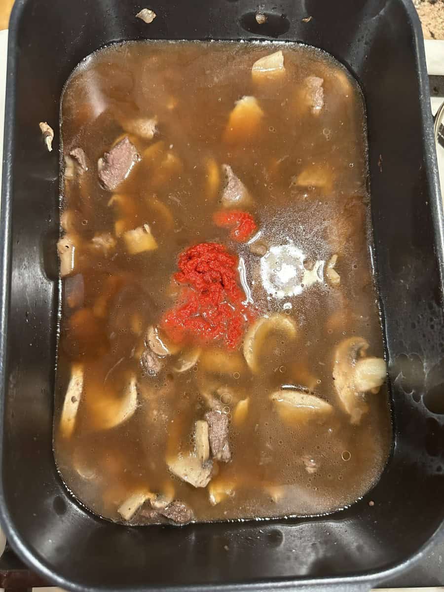 Added Beef Broth and Tomato Paste to Elk Backstrap in the pan.