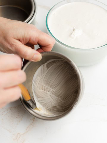Spreading Pan Grease in a Cake Pan with a Pastry Brush