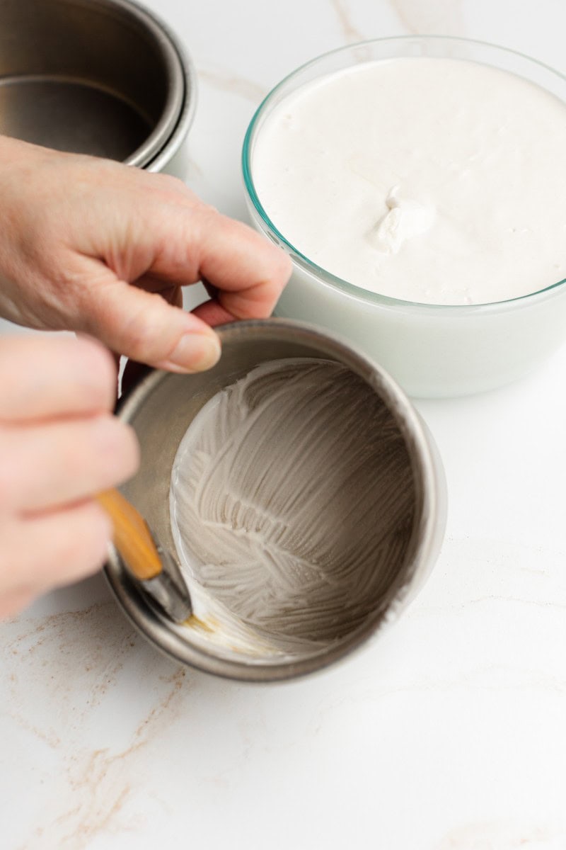 Spreading Pan Grease in a Cake Pan with a Pastry Brush