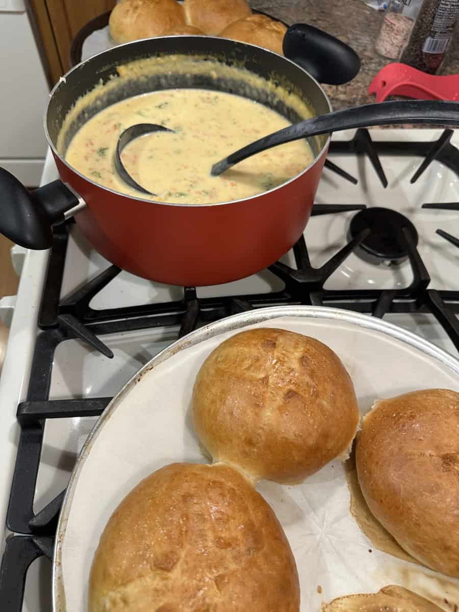 Bread Bowls along side a pot of cheesy broccoli soup