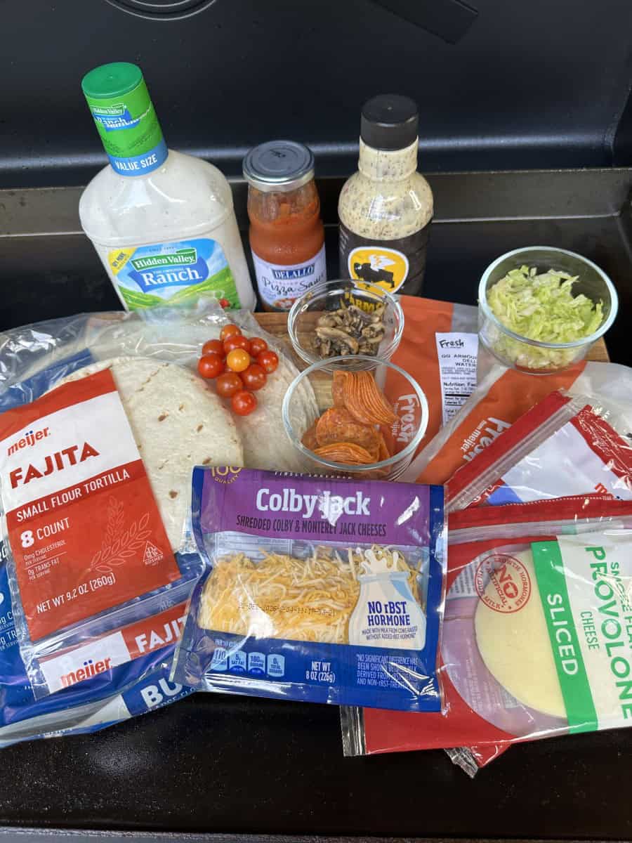 Pinwheel Ingredients: Flour Tortilla Shells, Cheese (Shredded and Slices), Sauces, and Pizza Toppings
