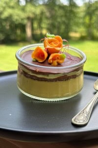 Creme Brulee with Dubai Chocolate on the top on a serving plate with a spoon