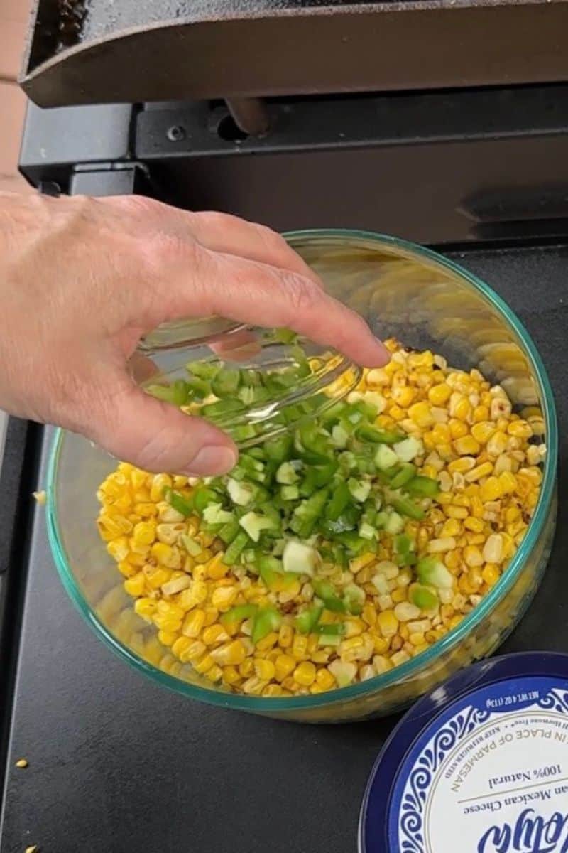 Diced Jalapenos added to fried corn