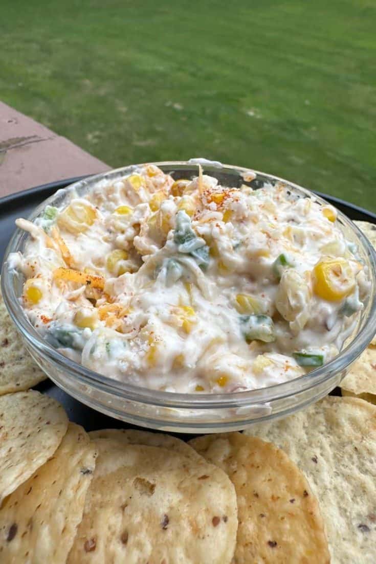 Street Corn Dip Recipe in a small bowl with a side of tortilla chips
